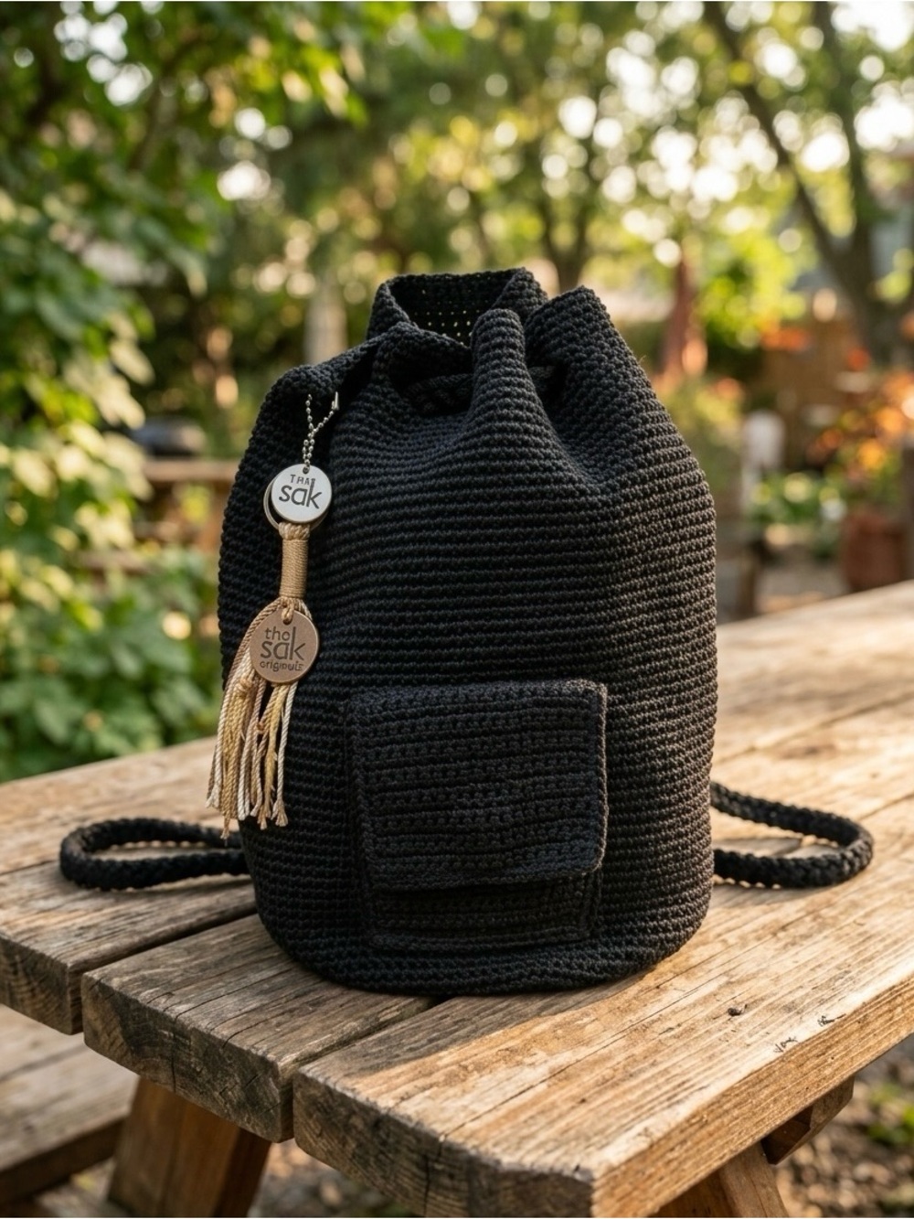 The Sak Black Crochet Drawstring Backpack with Tassel Charm